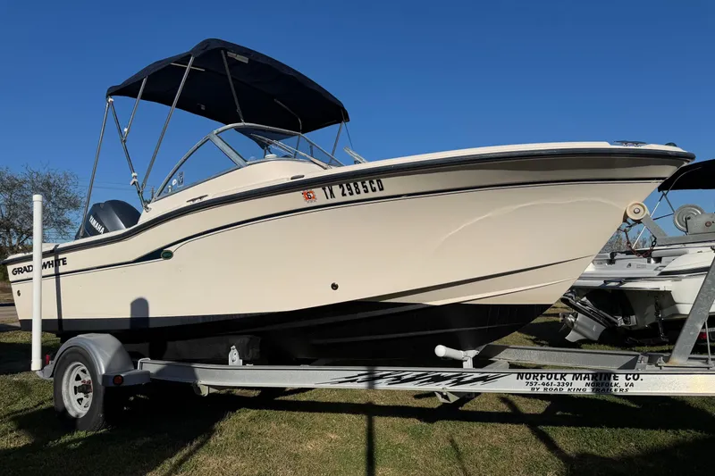 Slide: The Image of 2006 Grady-White Tournament 185 boat on trailer, side view under clear blue sky. - 2
