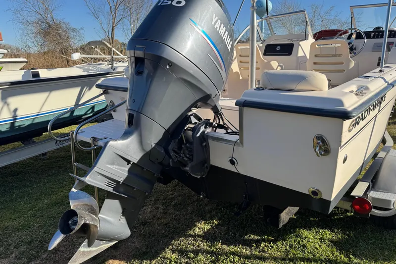 Slide: The Image of 2006 Grady-White Tournament 185 boat with Yamaha 150 outboard motor, parked on grass. - 7