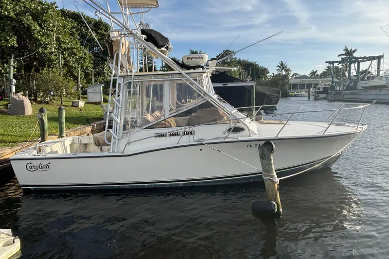 The Image of 2003 Carolina Classic 28 boat docked by a scenic waterfront. - 1