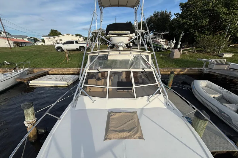 Slide: The Image of 2003 Carolina Classic 28 boat docked at marina, view from bow. - 18