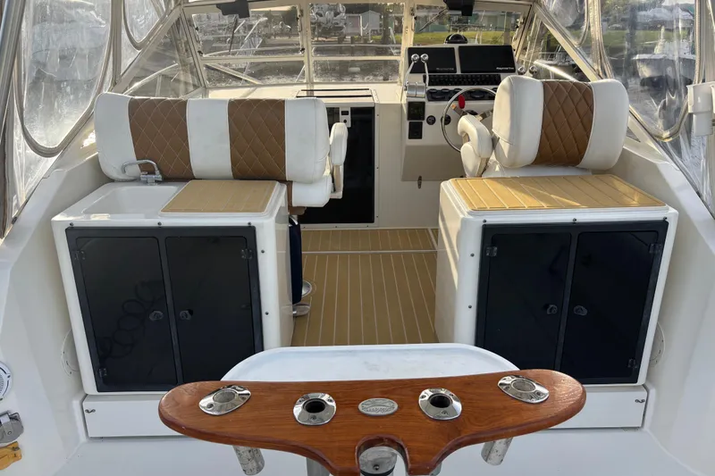 Slide: The Image of Interior of a 2003 Carolina Classic 28 boat with seating and control panel. - 21