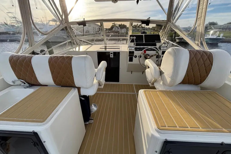 Slide: The Image of 2003 Carolina Classic 28 boat interior with leather seating and modern dashboard controls. - 23