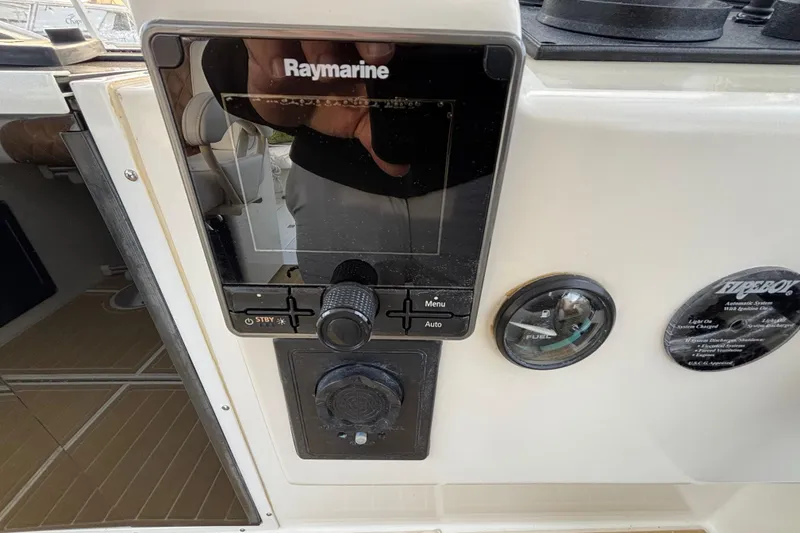 Slide: The Image of Raymarine navigation system on 2003 Carolina Classic 28 boat dashboard. - 31