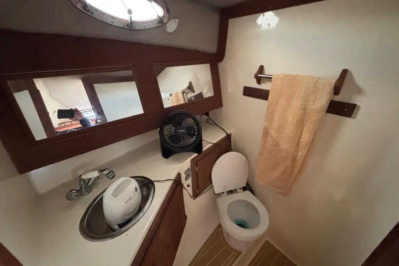 Slide: The Image of 2003 Carolina Classic 28 boat bathroom with sink, toilet, and towel rack. - 36