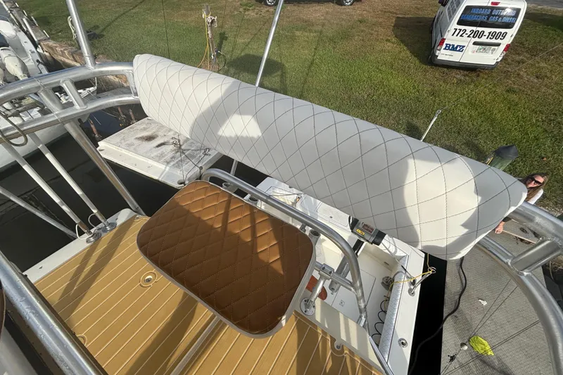 Slide: The Image of 2003 Carolina Classic 28 boat with cushioned seating area. - 42