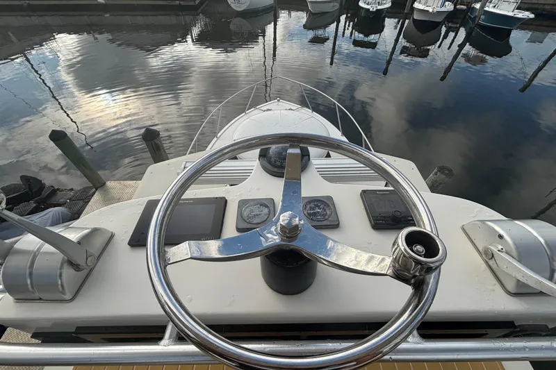 Slide: The Image of Helm of a 2003 Carolina Classic 28 at the marina. - 46