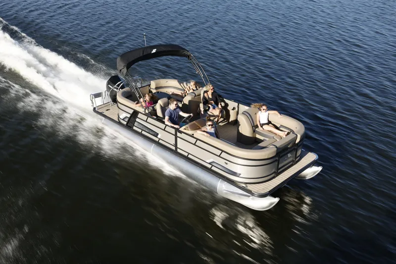 The Image of 2026 Starcraft EXS 3 R pontoon boat cruising on a lake with passengers enjoying the ride. - 1