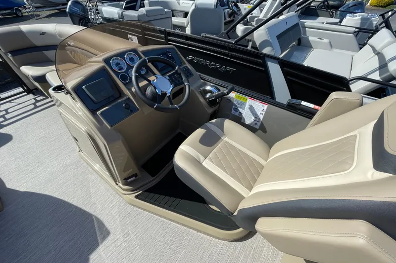Slide: The Image of 2026 Starcraft EXS 3 R boat interior with beige seating and modern dashboard. - 3