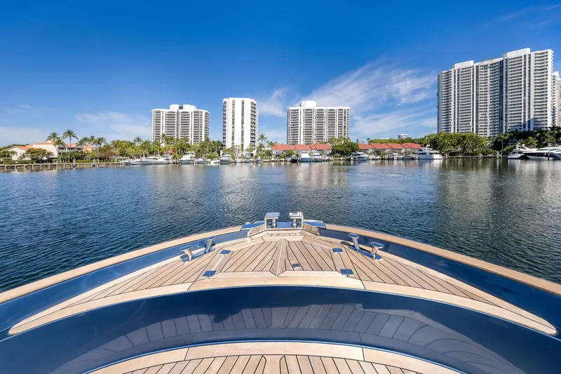 Slide: The Image of Bow view of 2021 Solaris Power 48 OPEN yacht in a marina with skyscrapers. - 13
