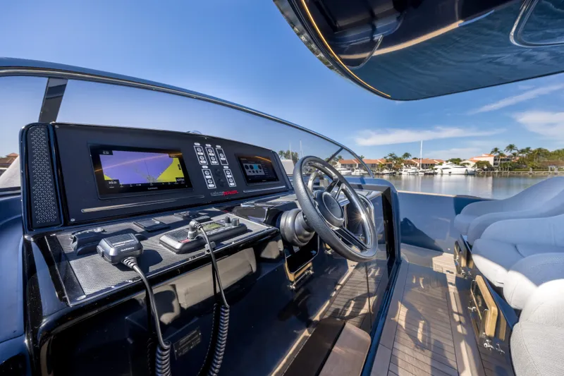 Slide: The Image of Cockpit of 2021 Solaris Power 48 OPEN yacht with modern navigation equipment and steering wheel. - 18