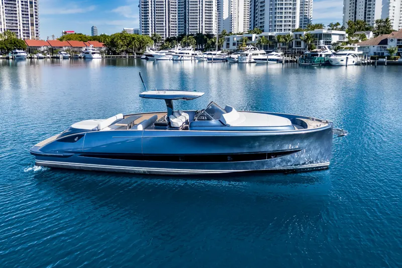 Slide: The Image of 2021 Solaris Power 48 OPEN yacht on calm water with city skyline backdrop. - 2