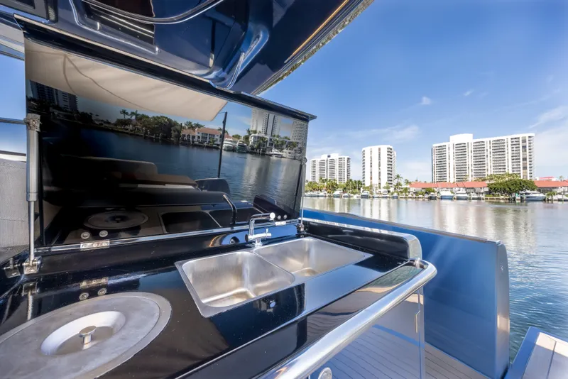 Slide: The Image of Solaris Power 48 OPEN 2021 yacht with outdoor sink and cityscape view. - 20