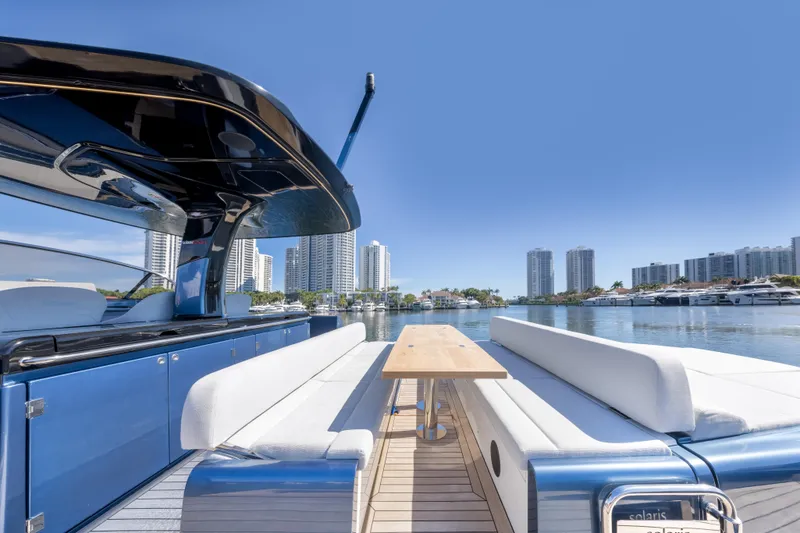 Slide: The Image of 2021 Solaris Power 48 OPEN yacht with sleek design, docked in a modern city marina. - 26