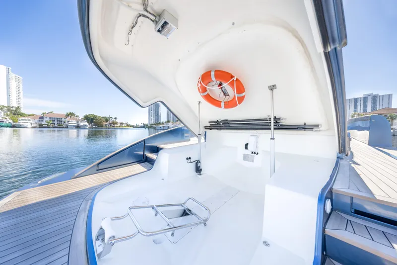 Slide: The Image of 2021 Solaris Power 48 OPEN yacht interior with life preserver, docked by waterfront buildings. - 31