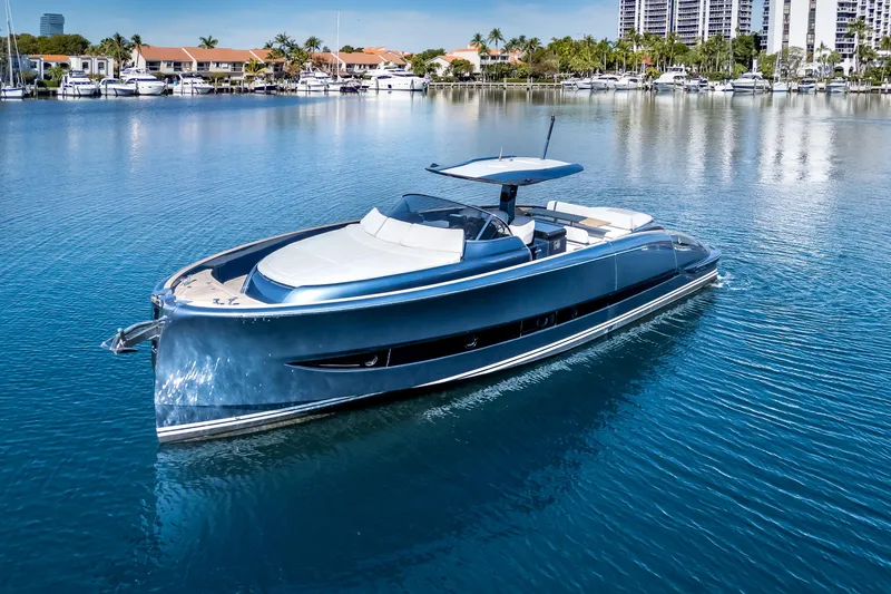 Slide: The Image of 2021 Solaris Power 48 OPEN yacht on calm water, with marina and palm trees in background. - 5