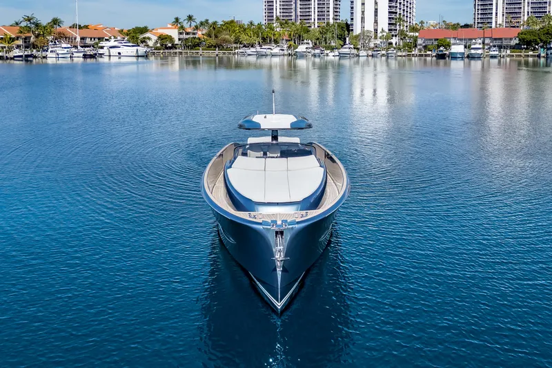 Slide: The Image of 2021 Solaris Power 48 OPEN yacht on calm water, with a scenic marina backdrop. - 6