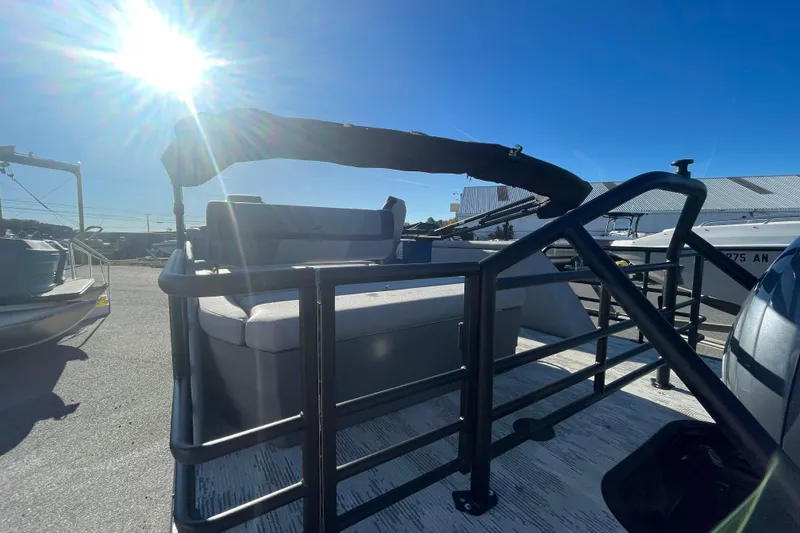 Slide: The Image of 2026 Starcraft SLS 3 RL pontoon boat with sunshade, docked under clear blue sky. - 10