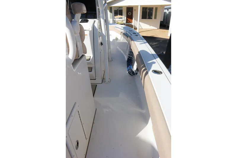 Slide: The Image of 2020 Sportsman Masters 267OE Bay Boat interior with seating and storage compartments. - 12