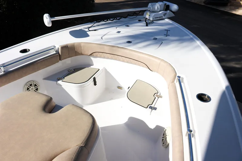 Slide: The Image of 2020 Sportsman Masters 267OE Bay Boat interior with cushioned seating and storage compartments. - 19