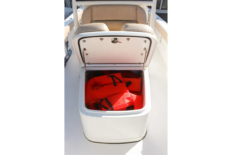 Slide: The Image of Open storage compartment on 2020 Sportsman Masters 267OE Bay Boat with life jackets inside. - 21