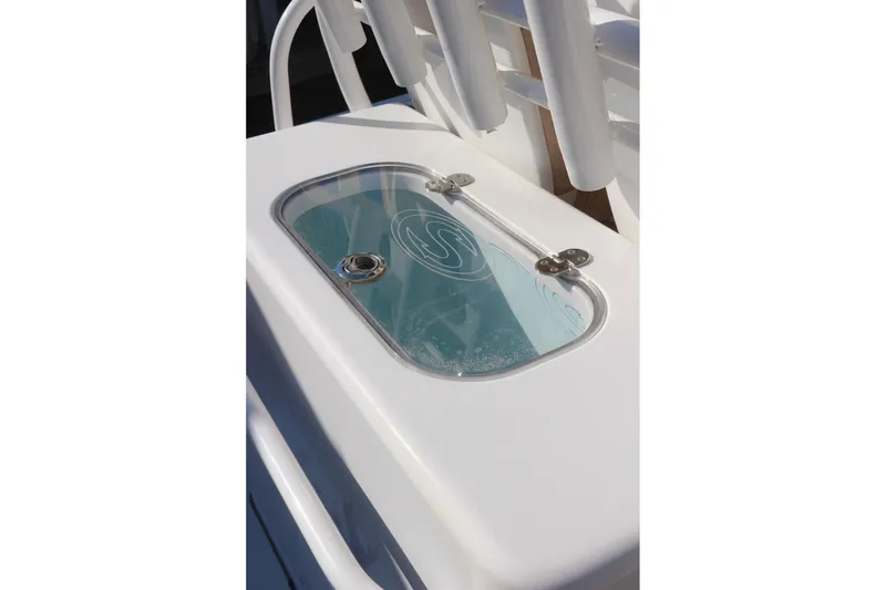 Slide: The Image of Livewell on 2020 Sportsman Masters 267OE Bay Boat, featuring a clear lid and secure latches. - 27