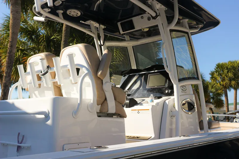 Slide: The Image of 2020 Sportsman Masters 267OE Bay Boat with dual seats and console, surrounded by palm trees. - 29