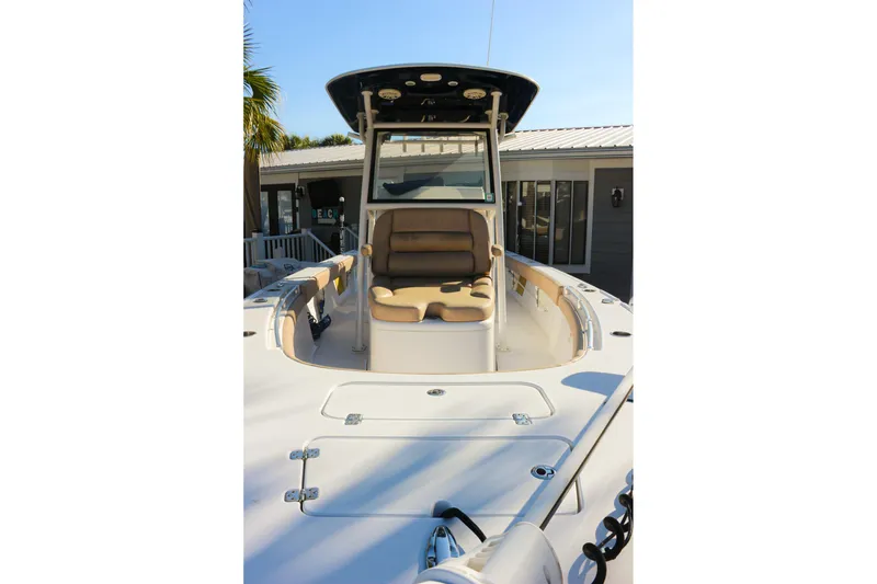 Slide: The Image of 2020 Sportsman Masters 267OE Bay Boat with seating and console, docked near a house. - 3