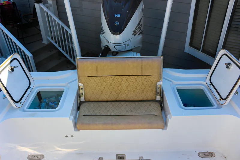 Slide: The Image of 2020 Sportsman Masters 267OE Bay Boat with tan seating and storage compartments. - 7