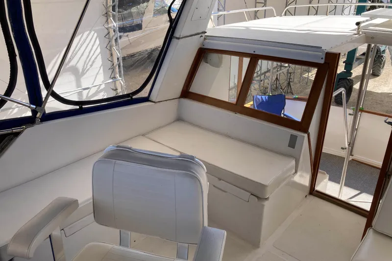 Slide: The Image of 1986 Heritage East Sundeck interior with white seating and wooden accents. - 13