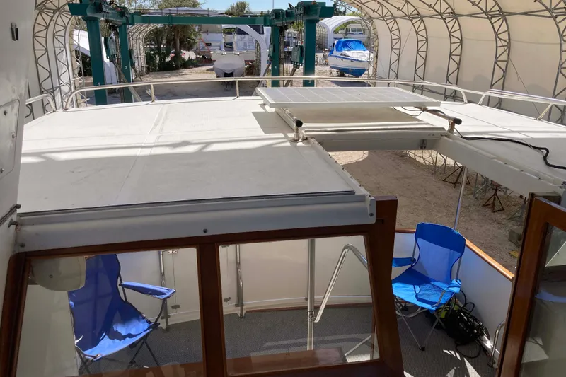 Slide: The Image of 1986 Heritage East Sundeck boat interior with blue chairs and solar panel. - 14