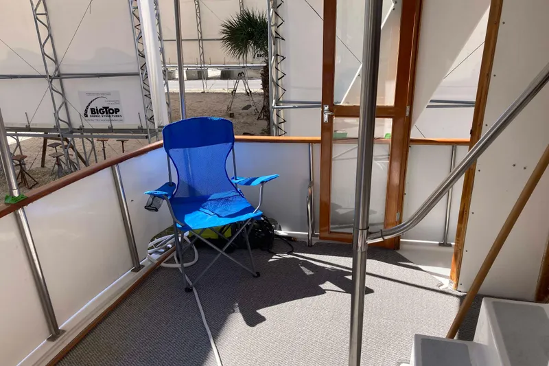 Slide: The Image of 1986 Heritage East Sundeck interior with blue chair, metal railings, and wooden door. - 15