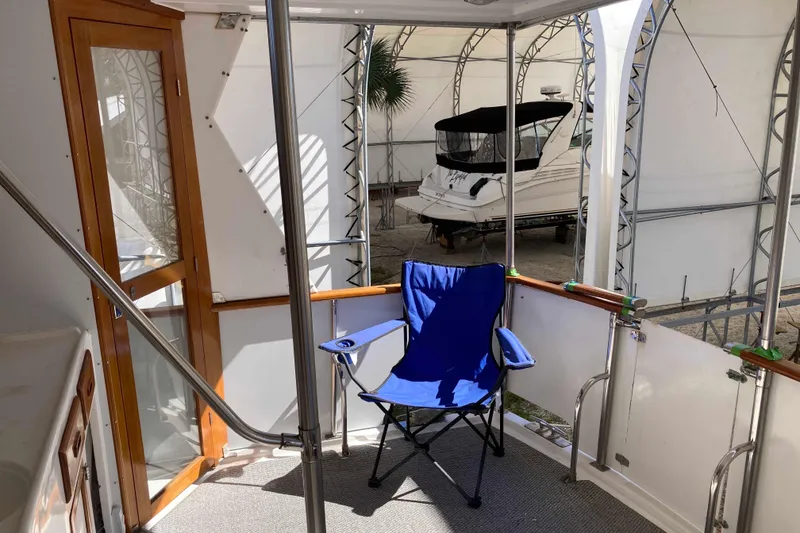 Slide: The Image of 1986 Heritage East Sundeck interior with blue chair and wooden door. - 16