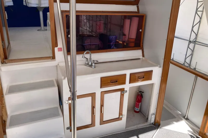 Slide: The Image of 1986 Heritage East Sundeck interior with sink, cabinets, and fire extinguisher. - 17