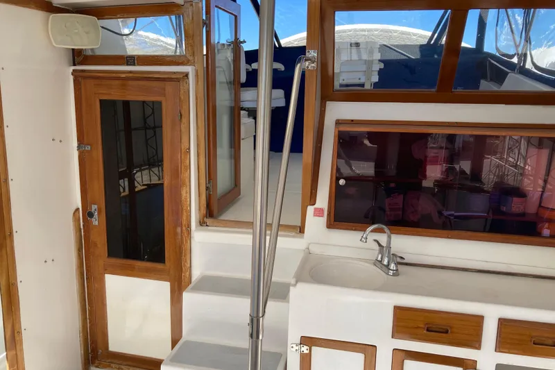 Slide: The Image of 1986 Heritage East Sundeck interior with wooden doors, sink, and stairs. - 18