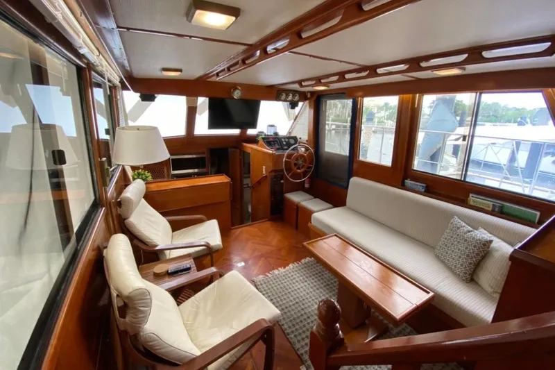 Slide: The Image of 1986 Heritage East Sundeck interior with wooden furnishings and cozy seating area. - 19