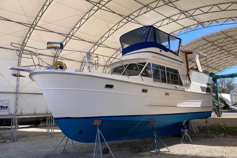 Slide: The Image of 1986 Heritage East Sundeck boat on stands in covered storage area. - 2