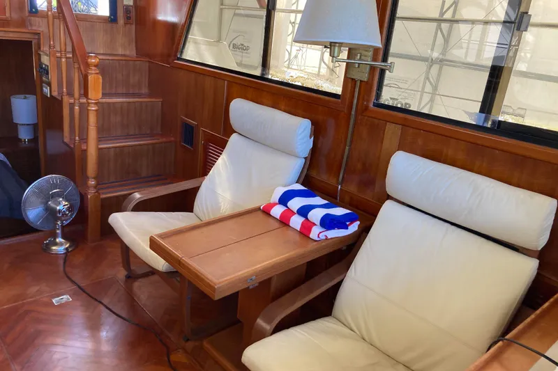 Slide: The Image of Interior of 1986 Heritage East Sundeck yacht with wooden paneling and comfortable seating. - 23