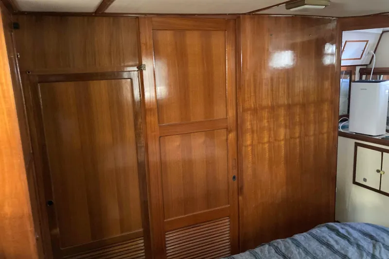 Slide: The Image of 1986 Heritage East Sundeck interior with polished wooden paneling and compact storage. - 31