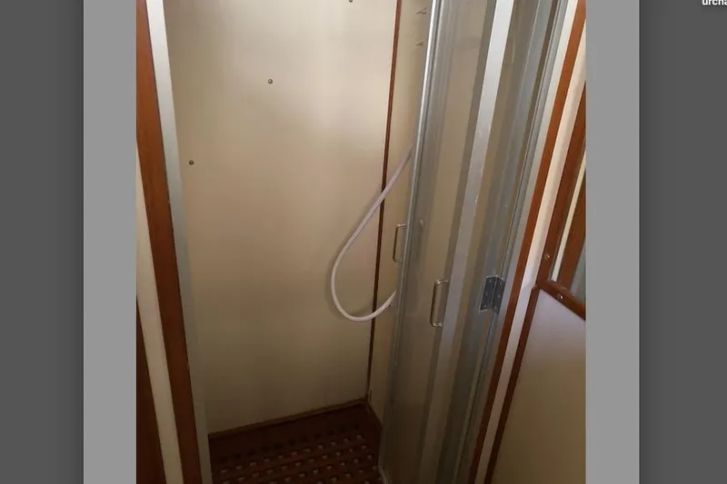 Slide: The Image of 1986 Heritage East Sundeck shower area with glass door and wooden accents. - 34