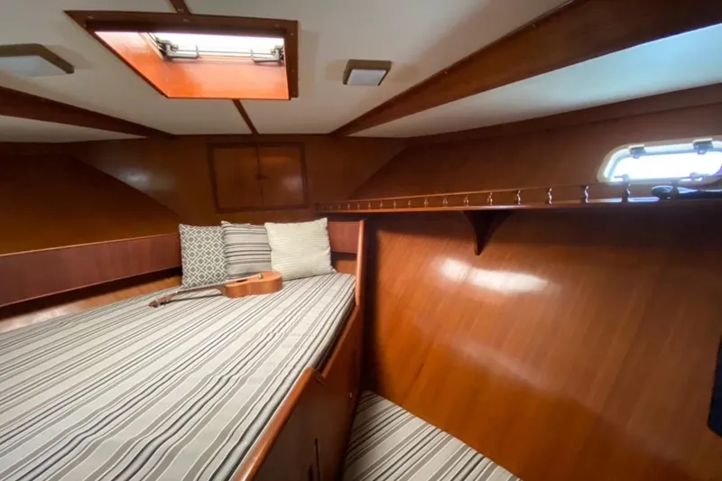 Slide: The Image of Cozy 1986 Heritage East Sundeck cabin with striped bedding and a ukulele. - 36