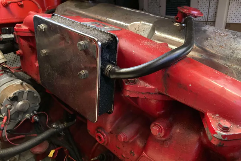 Slide: The Image of 1986 Heritage East Sundeck engine detail with red components and metal plate. - 39