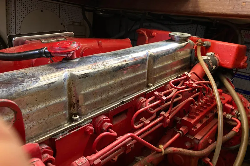 Slide: The Image of 1986 Heritage East Sundeck engine compartment with red mechanical components and metal cover. - 40