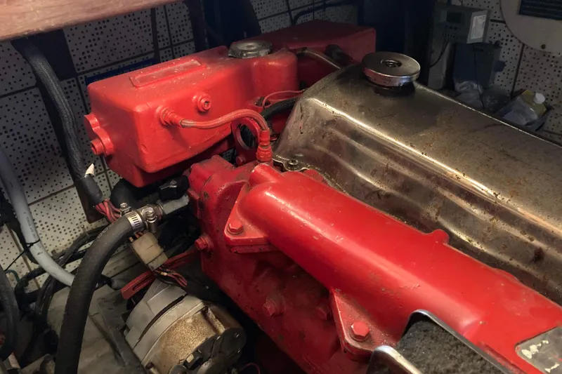 Slide: The Image of Engine compartment of a 1986 Heritage East Sundeck boat, featuring red components. - 41