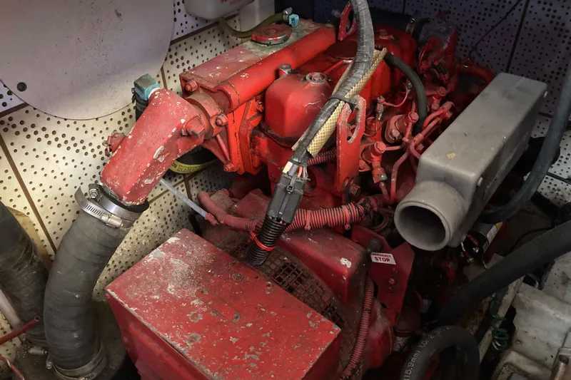 Slide: The Image of Engine room of 1986 Heritage East Sundeck with red machinery and hoses. - 42