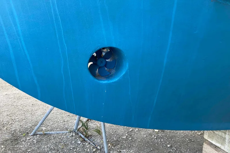 Slide: The Image of 1986 Heritage East Sundeck boat hull with visible bow thruster. - 44