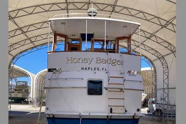 Slide: The Image of 1986 Heritage East Sundeck boat named "Honey Badger" in covered storage, Naples, FL. - 5