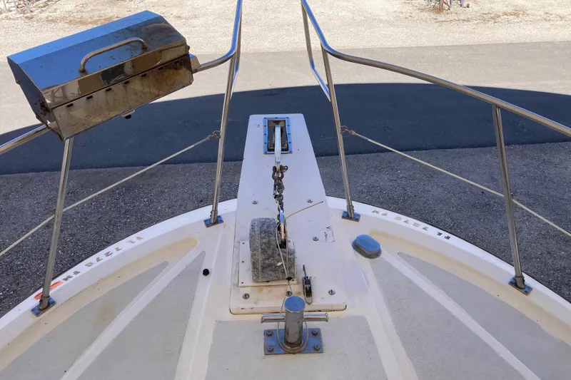 Slide: The Image of Bow of 1986 Heritage East Sundeck boat with anchor and grill. - 6