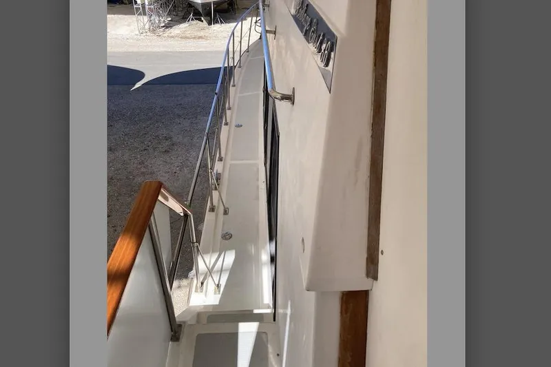 Slide: The Image of 1986 Heritage East Sundeck yacht walkway with railing and wooden handrail. - 9