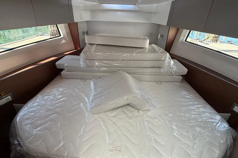Slide: The Image of Interior cabin of 2026 Beneteau Antares 9 with wrapped bedding and cushions. - 20