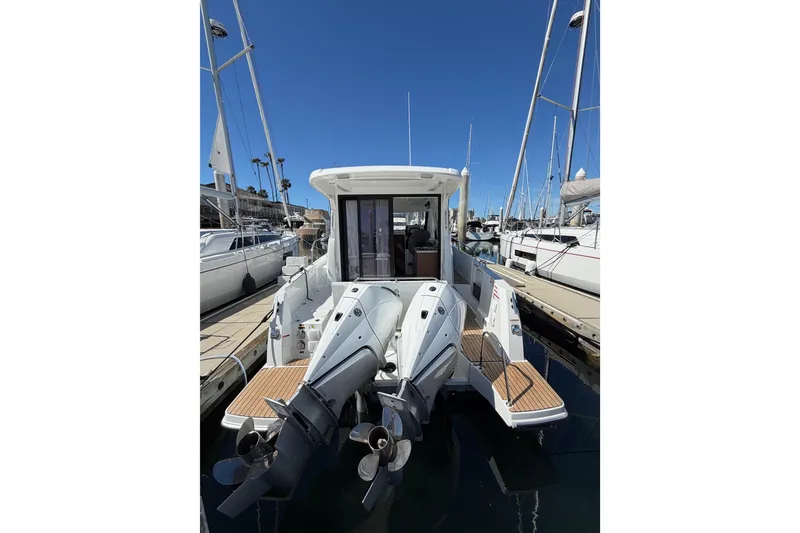 Slide: The Image of 2026 Beneteau Antares 9 boat docked, featuring dual outboard motors and sleek design. - 25